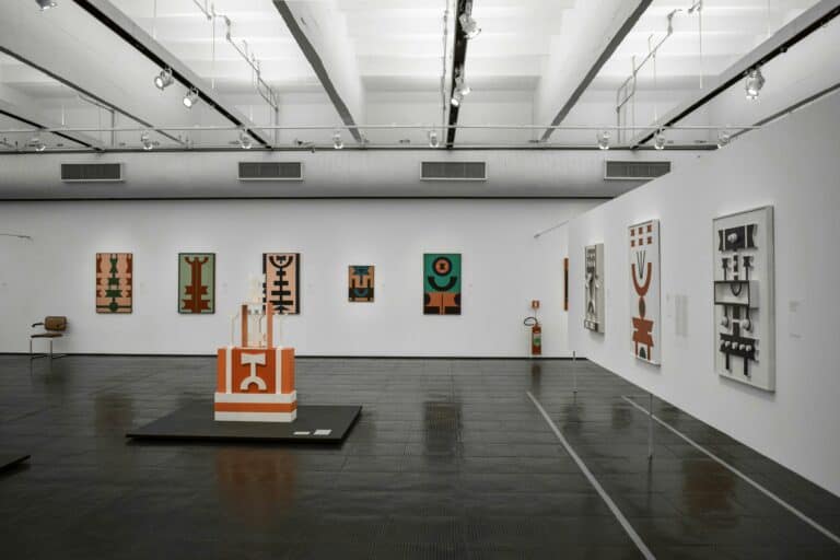 Spacious gallery showcasing contemporary abstract art pieces with geometric designs.